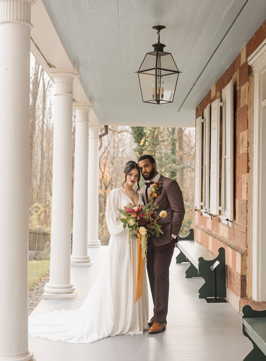 bride and groom in front of historic Stiegel-Coleman House at Elizabeth Furnace